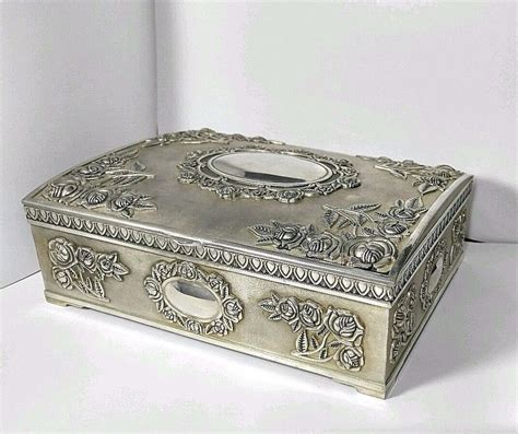 Center is two compartments as well as one larger. . Godinger jewelry box